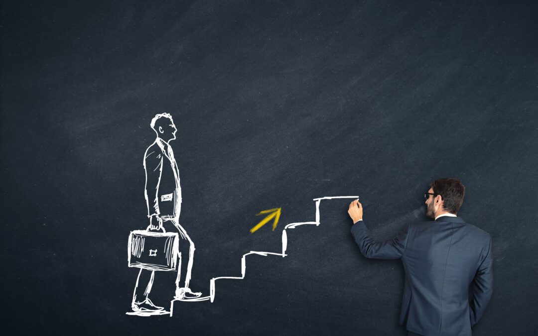 human hand drawing career ladder with chalk.